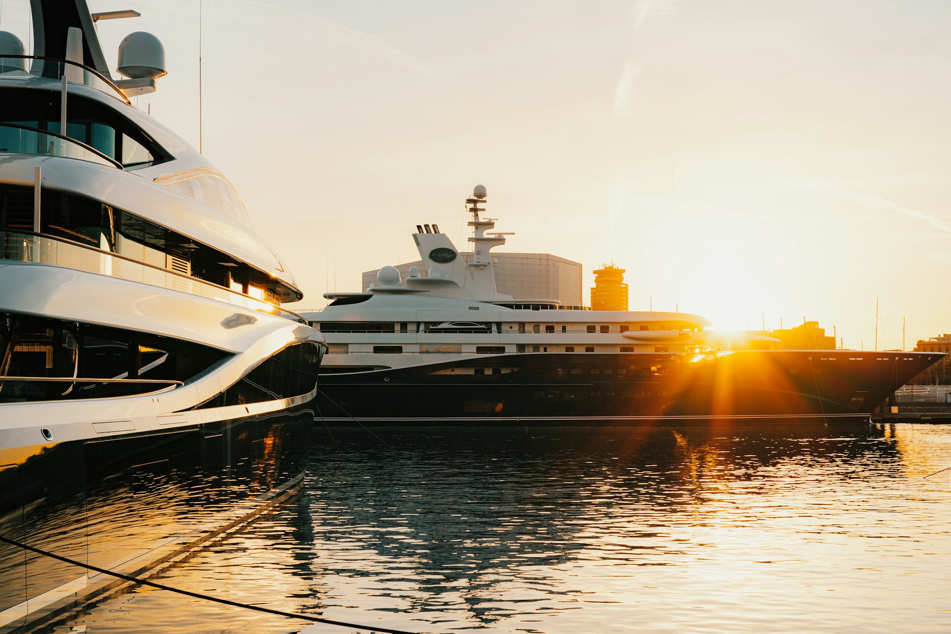 Warm sunset light reflected on luxury yachts in a marina